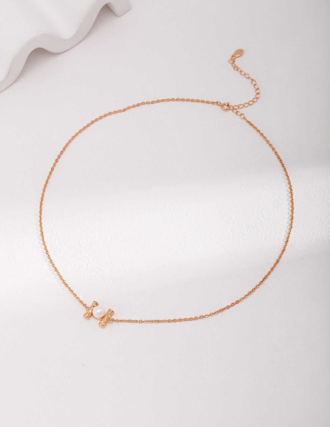 Minimalist 18K gold plated 925 silver necklace with natural freshwater pearl pendant on white background