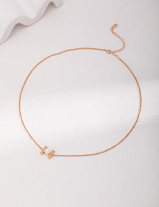 Minimalist 18K gold plated 925 silver necklace with natural freshwater pearl pendant on white background