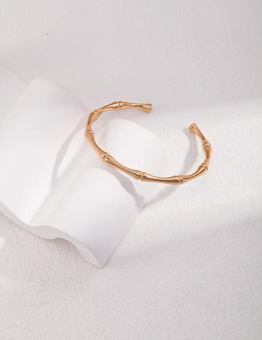 Bamboo texture open cuff bracelet in 18K gold plated 925 sterling silver on a white background