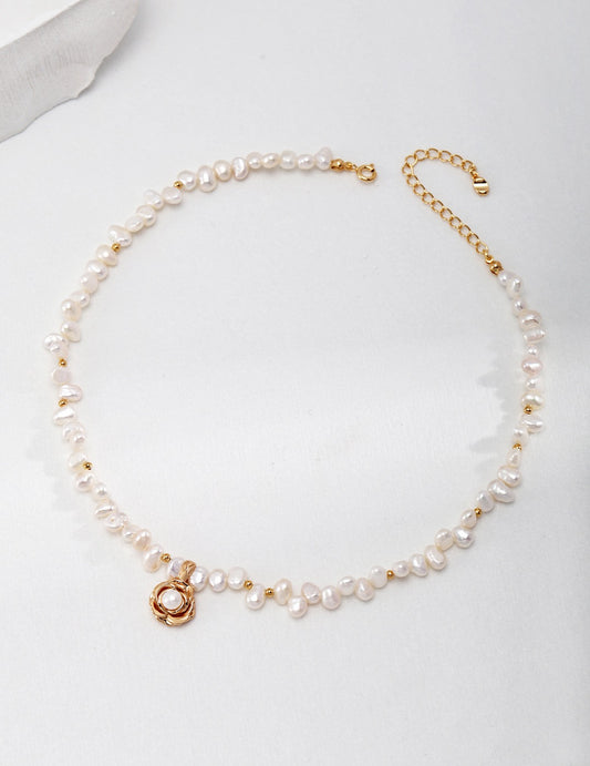 Camellia flower pearl necklace made of 18K gold plated 925 silver with natural freshwater pearls on a white background