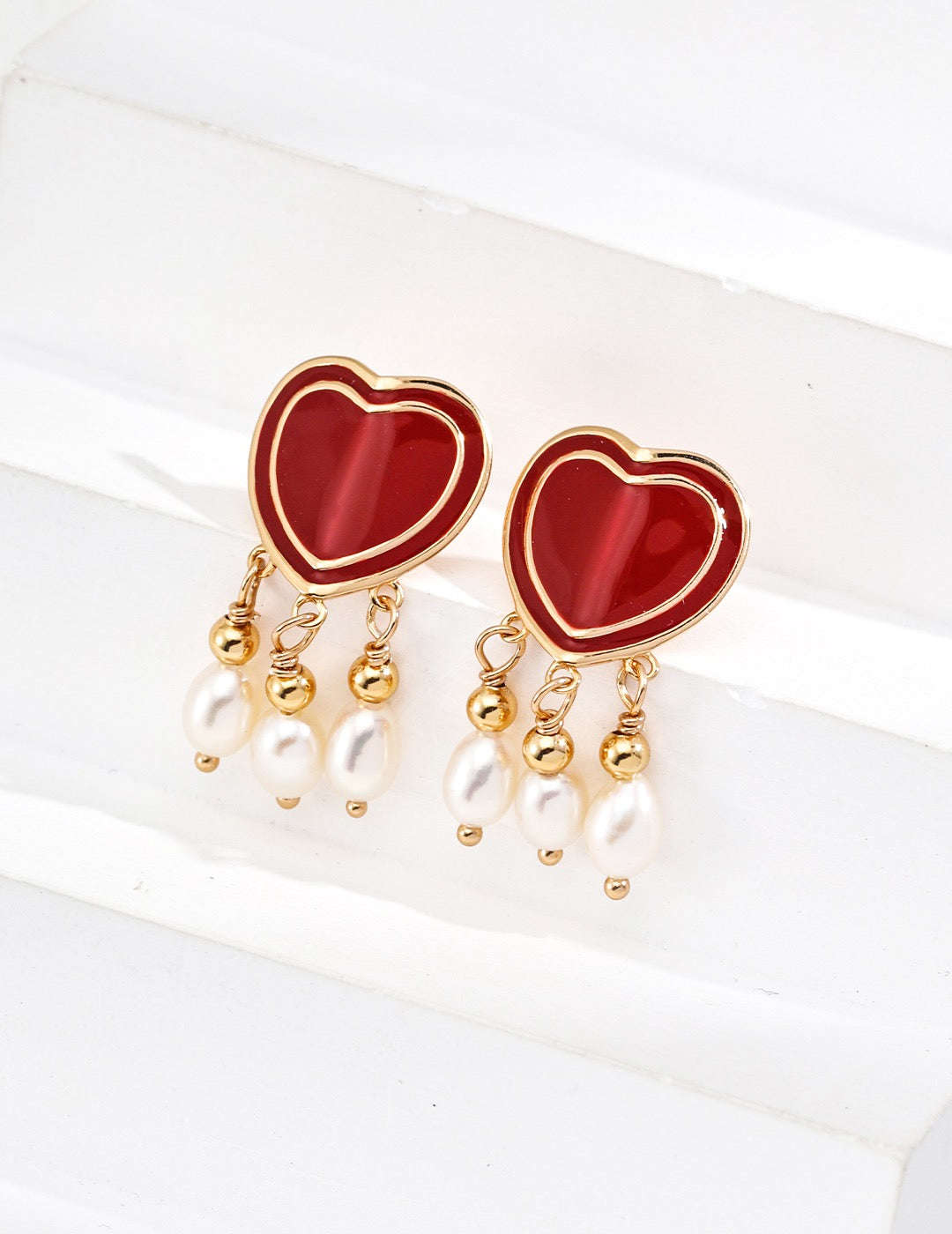 Luxury 18K gold-plated 925 silver earrings featuring red enamel heart tops and natural freshwater pearl drops — elegant romantic jewelry gift for her.