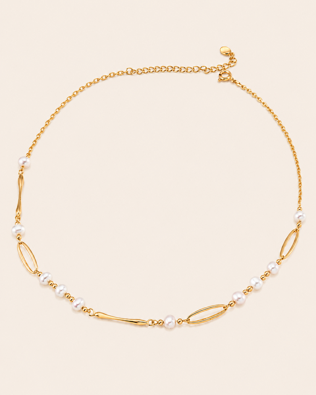 Minimalist gold chain necklace featuring freshwater pearls and elongated link details on a clean ivory background.