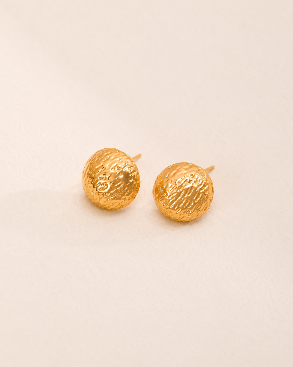 Solea Hammered Gold Stud Earrings featuring a textured dome silhouette and polished gold finish.