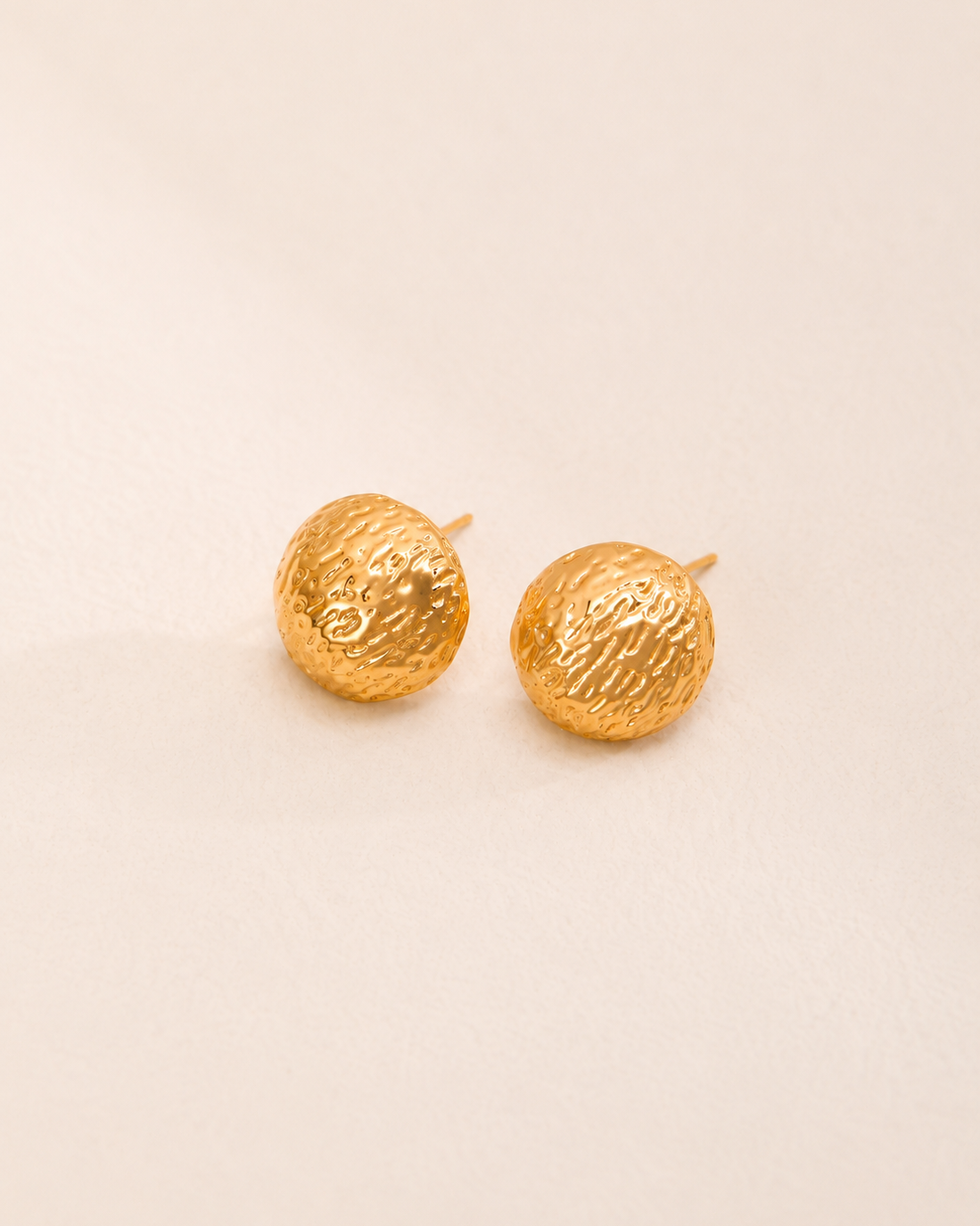 Solea Hammered Gold Stud Earrings featuring a textured dome silhouette and polished gold finish.
