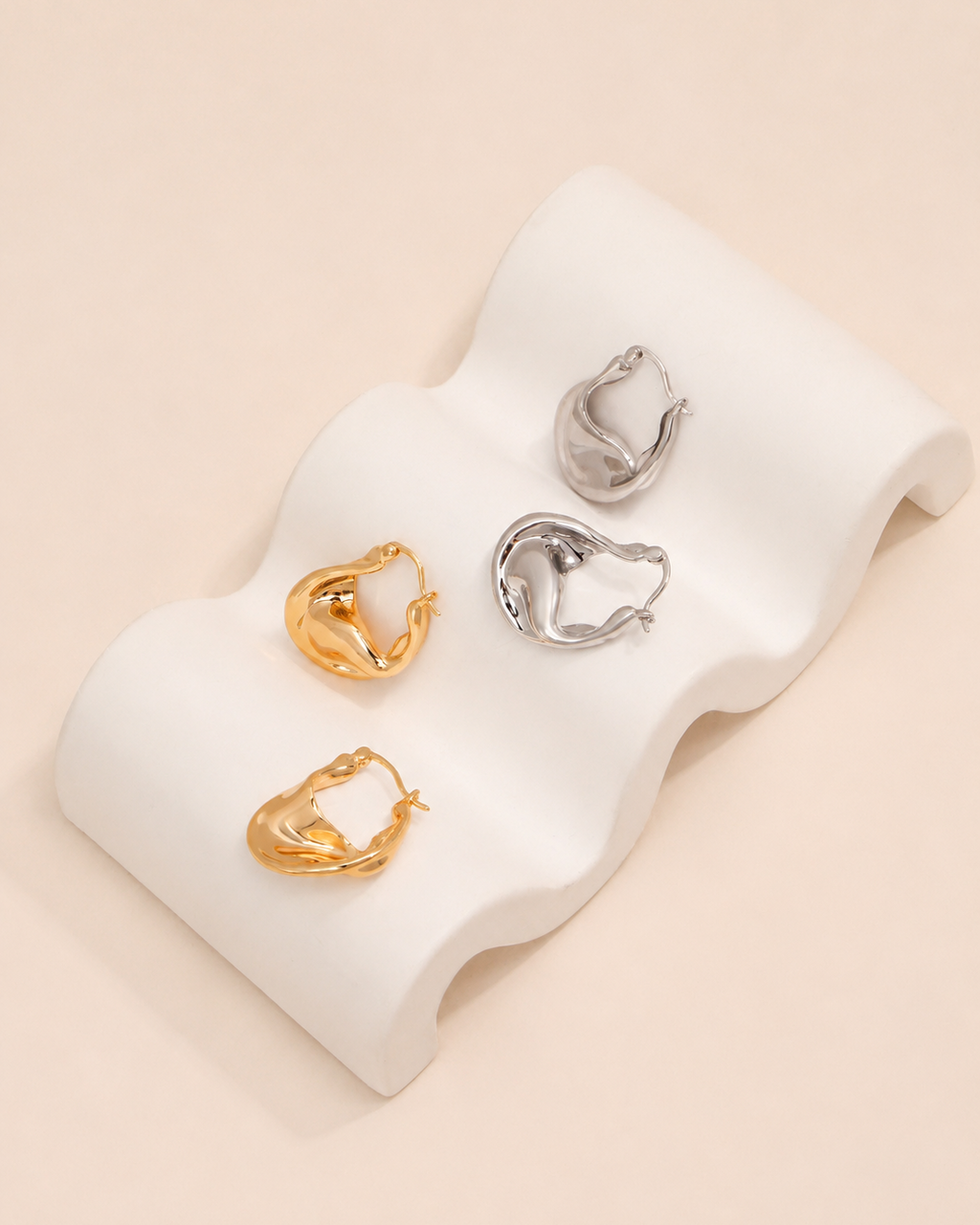 Aurelia twisted sculptural gold hoop earrings with organic wave design and polished gold finish