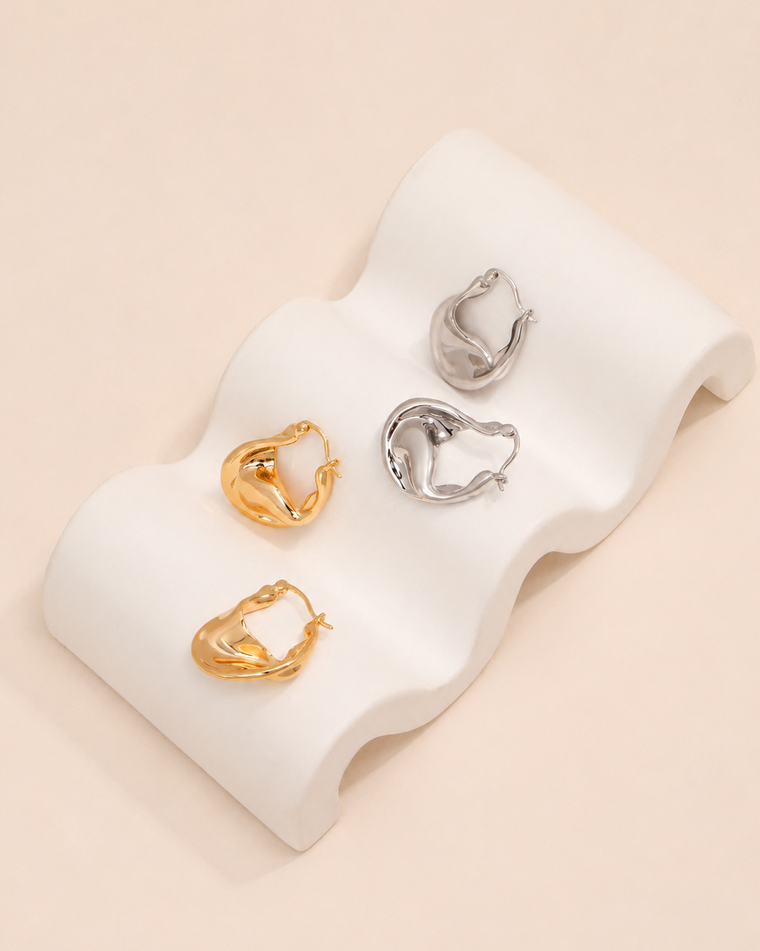 Aurelia twisted sculptural gold hoop earrings with organic wave design and polished gold finish