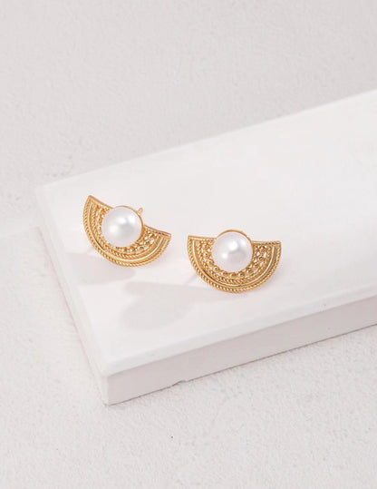 Elegant 18K gold-plated 925 silver half-moon stud earrings with natural freshwater pearls and vintage filigree design on a white background.