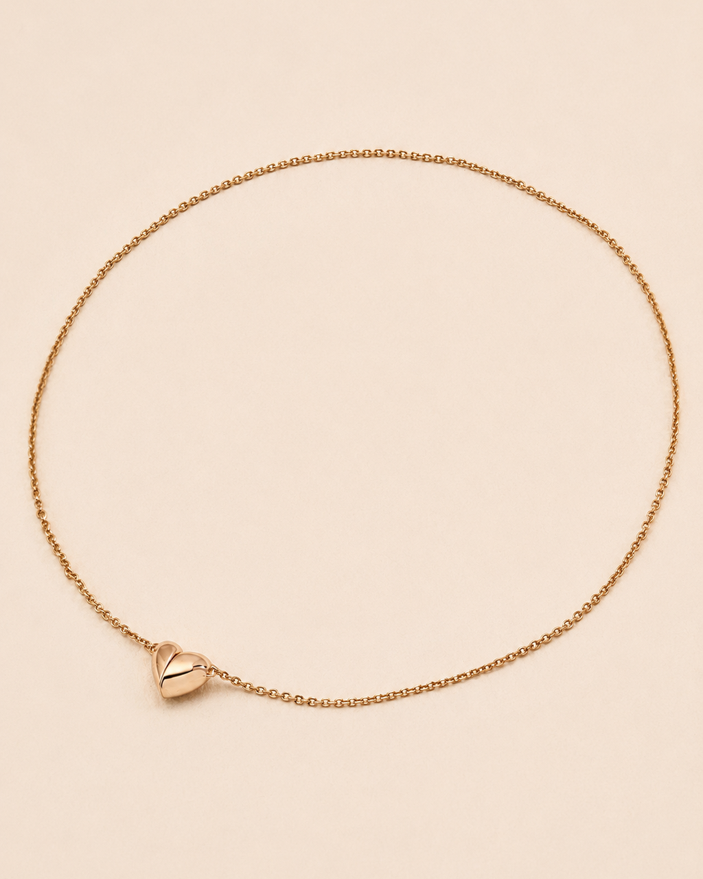 Minimalist magnetic heart necklace in 18K gold-plated sterling silver on a soft ivory background.