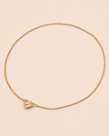 Minimalist magnetic heart necklace in 18K gold-plated sterling silver on a soft ivory background.