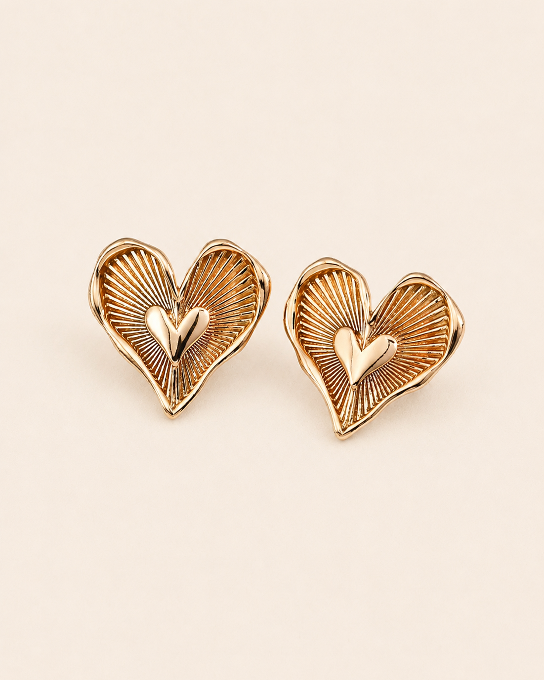 Gold heart stud earrings crafted from S925 sterling silver with thick 18K gold plating, featuring a vintage-inspired sunburst texture and sculpted heart center.