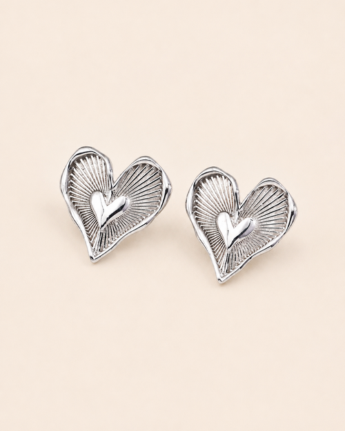 Heart stud earrings in S925 sterling silver with thick 18K white gold plating, showcasing intricate radiating details and a polished heart motif.