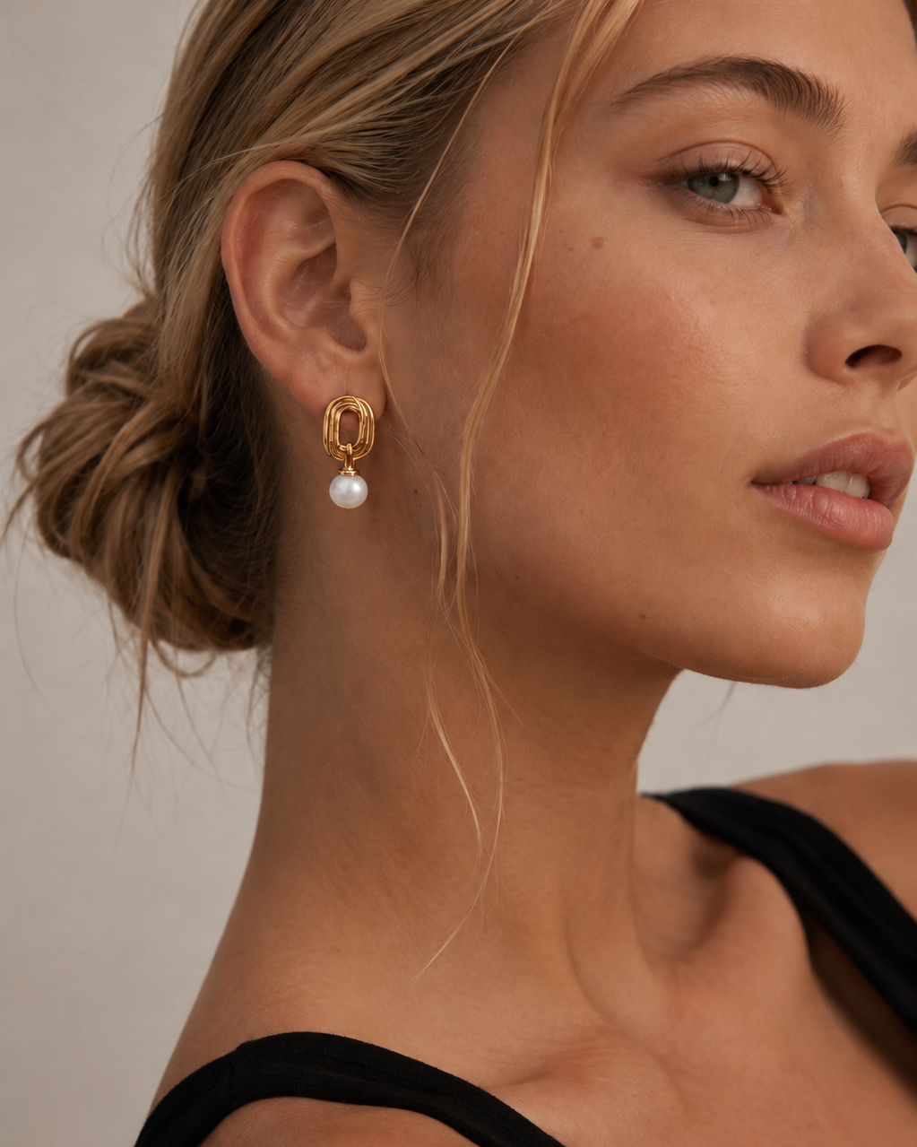 Close-up of a model wearing gold pearl drop earrings made from S925 sterling silver with 18K gold plating and natural freshwater pearls, showcasing a minimalist everyday jewelry look.