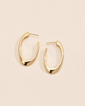 Modern sculptural hoop earrings in 18k gold plated sterling silver with a sleek organic silhouette.