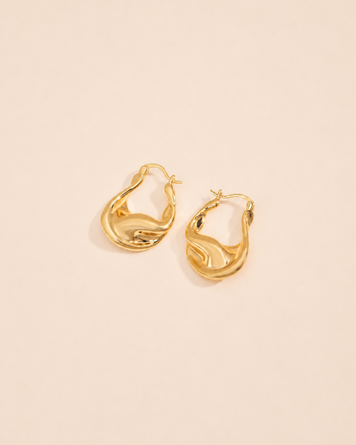 Aurelia twisted sculptural gold hoop earrings in a modern organic design with high-shine gold finish