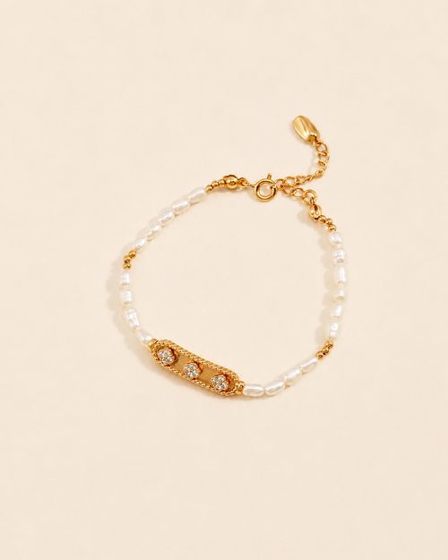 Natural freshwater pearl bracelet featuring a pavé zircon centerpiece in 18K gold plated sterling silver on a soft cream background.
