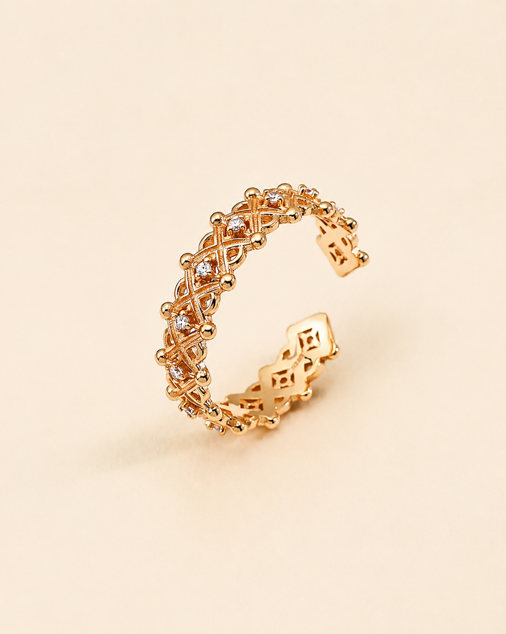Adjustable gold crown ring featuring sparkling cubic zirconia and vintage lattice detailing.