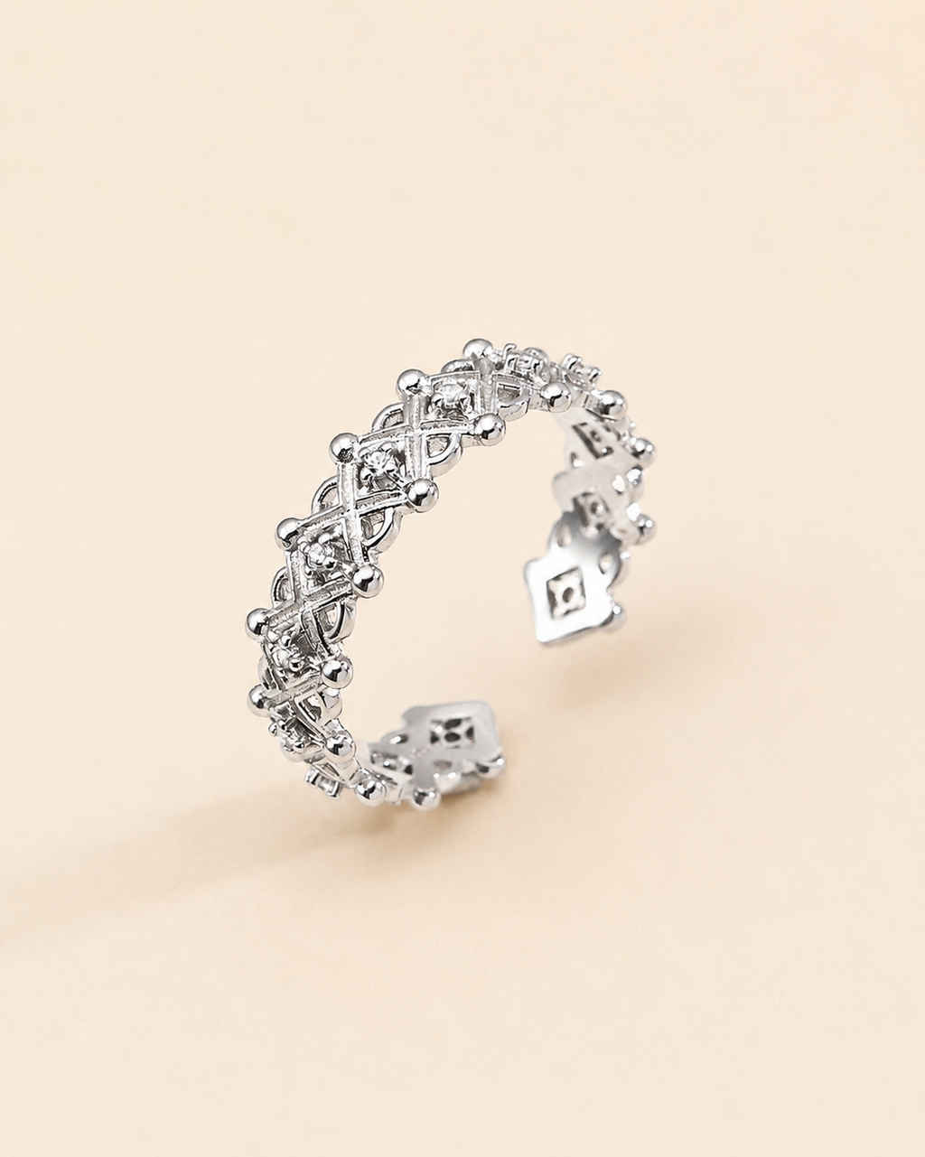 Adjustable silver crown ring with cubic zirconia accents and intricate openwork design.