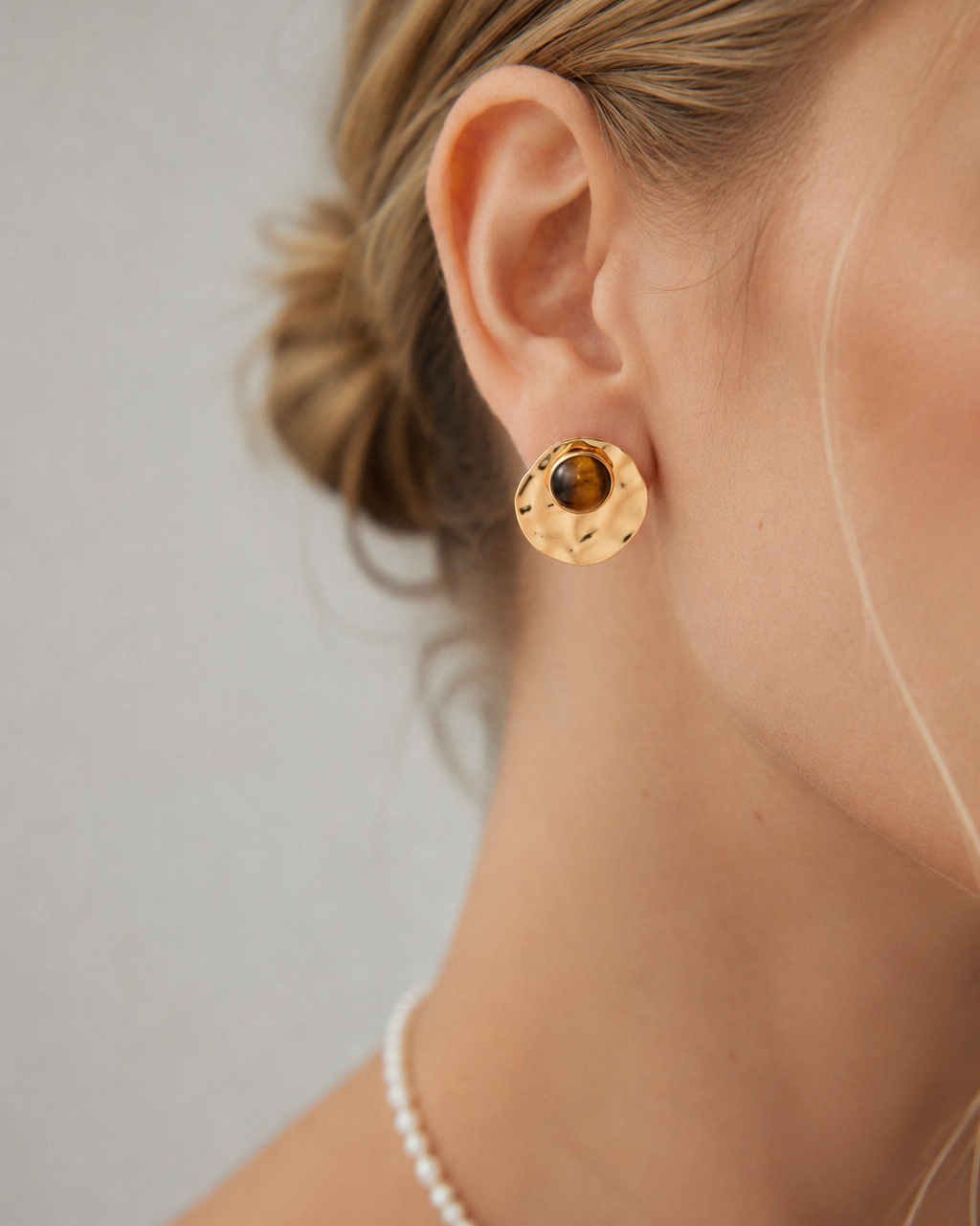 Close-up of convertible tiger eye statement earrings with detachable hammered gold discs, crafted in S925 sterling silver with thick 18K gold plating.