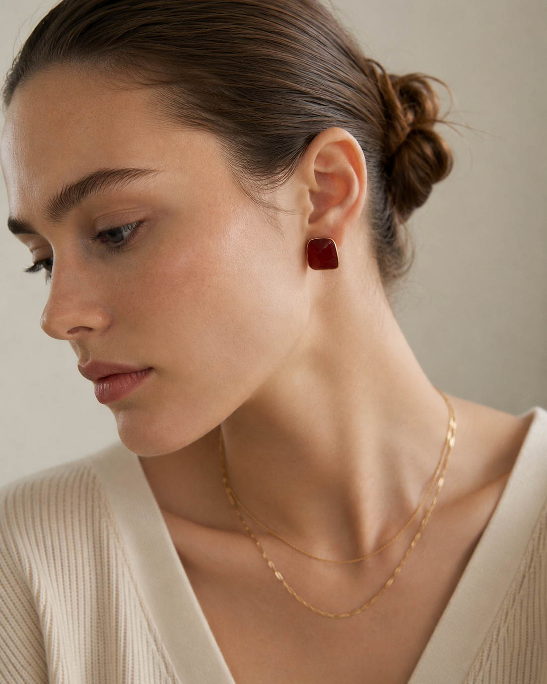 Model wearing burgundy enamel stud earrings in S925 sterling silver with thick 18K gold plating, styled for an elegant everyday look.