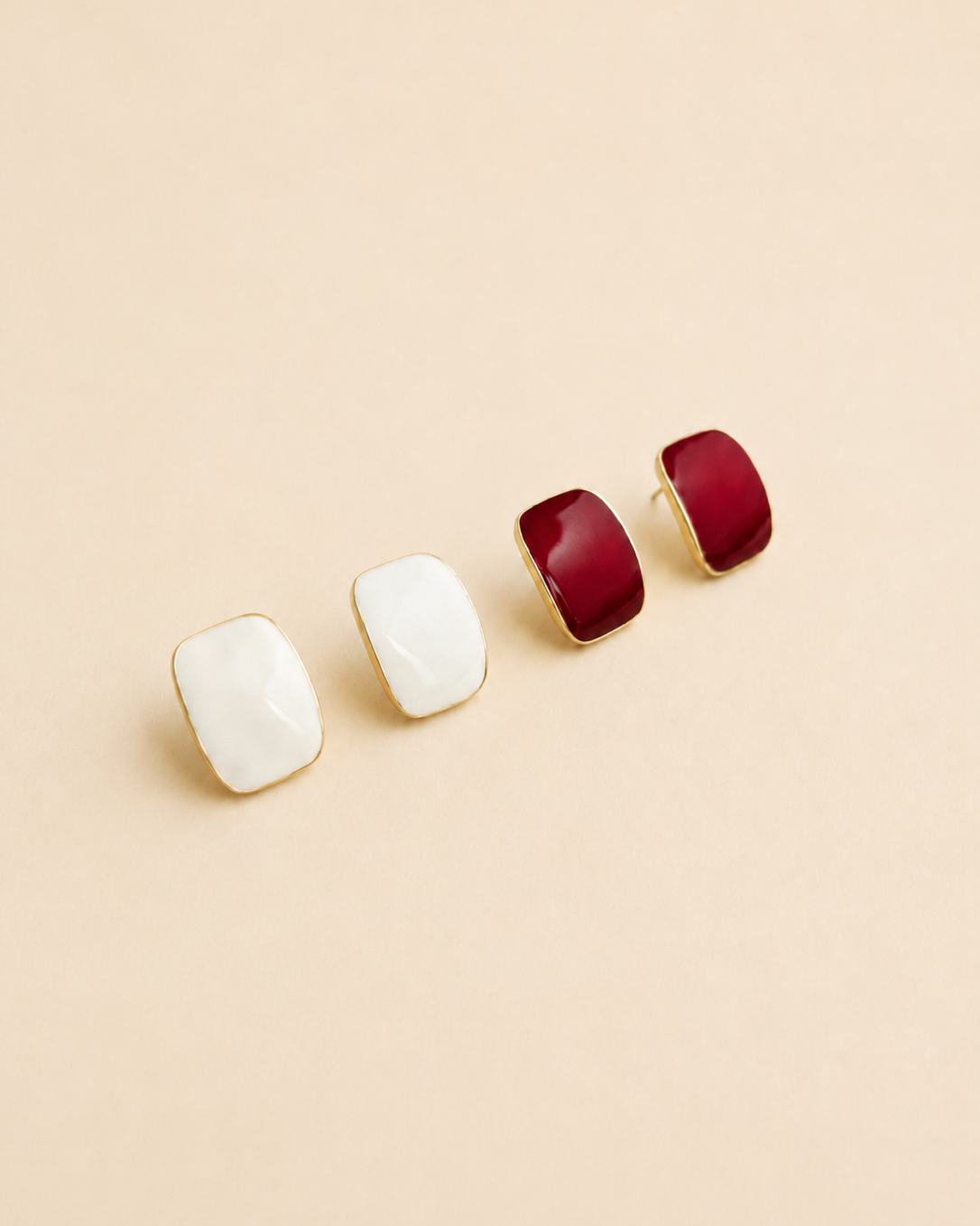 Éclat enamel stud earrings available in ivory and burgundy enamel, crafted from S925 sterling silver with thick 18K gold plating.