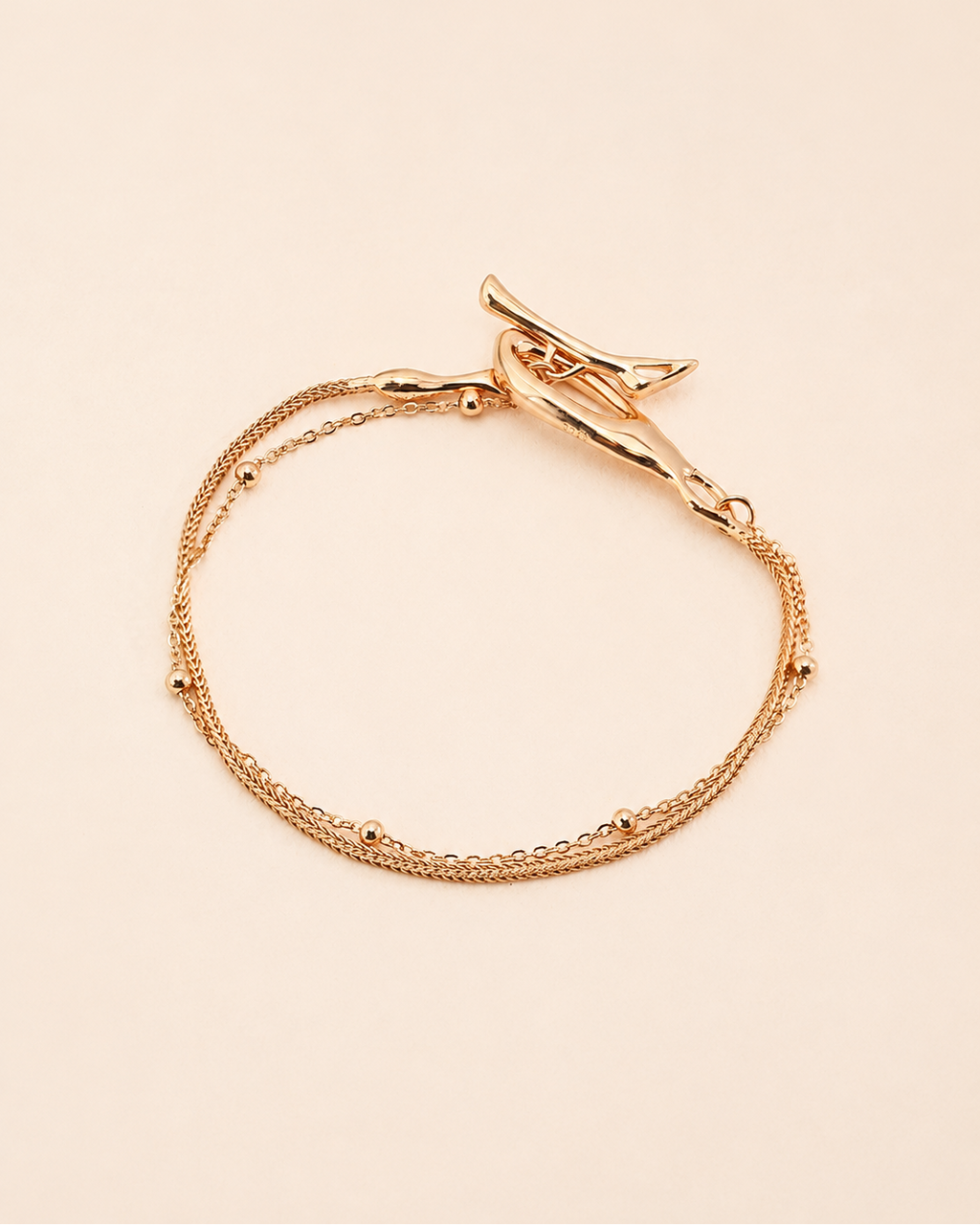 Gold Entwine Branch bracelet with organic sculptural clasp and layered chain design.