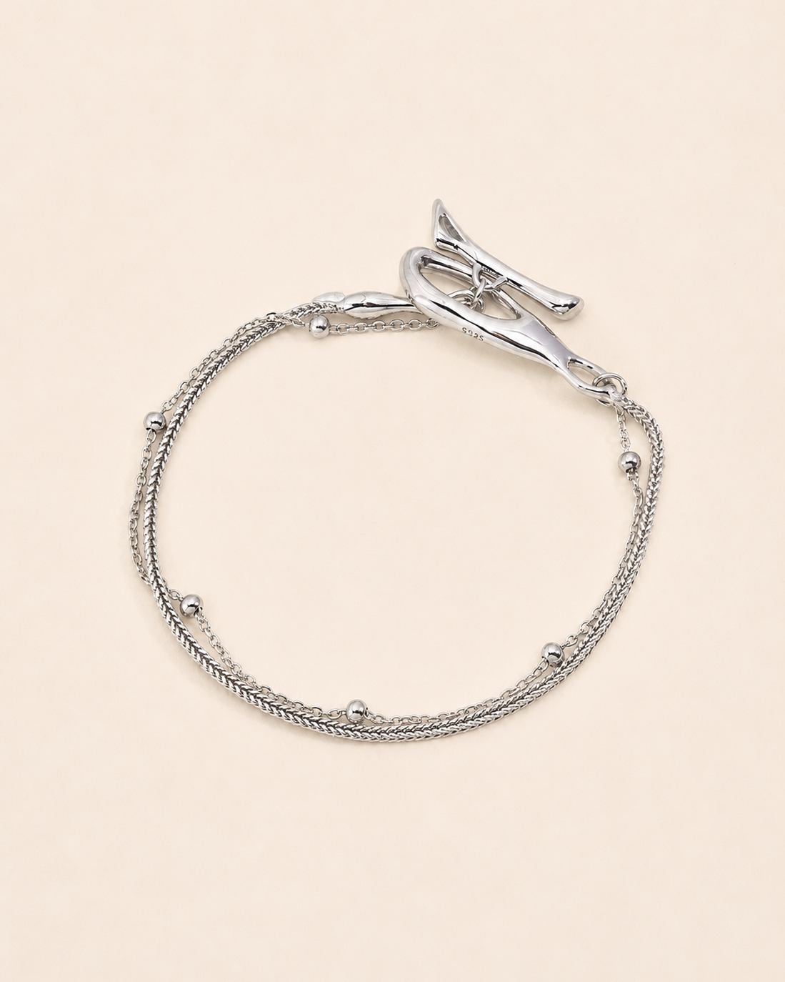 Silver Entwine Branch bracelet featuring an organic branch-inspired clasp and delicate layered chains.