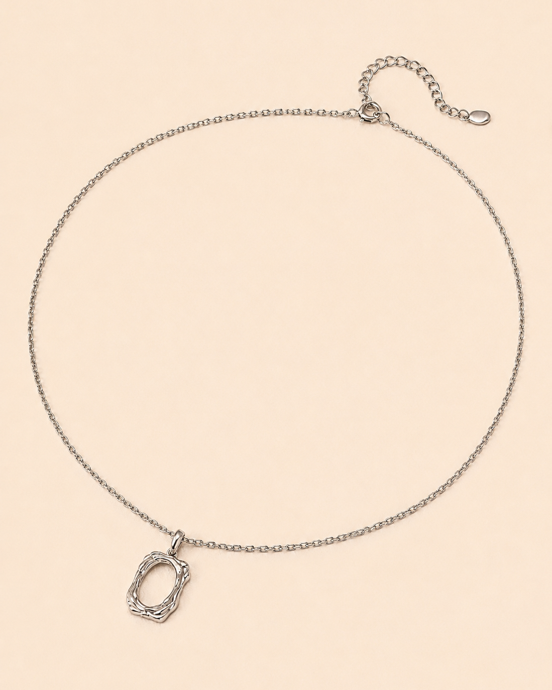 18K white gold plated sterling silver pendant necklace with an organic open-frame pendant, photographed on a minimalist beige background.