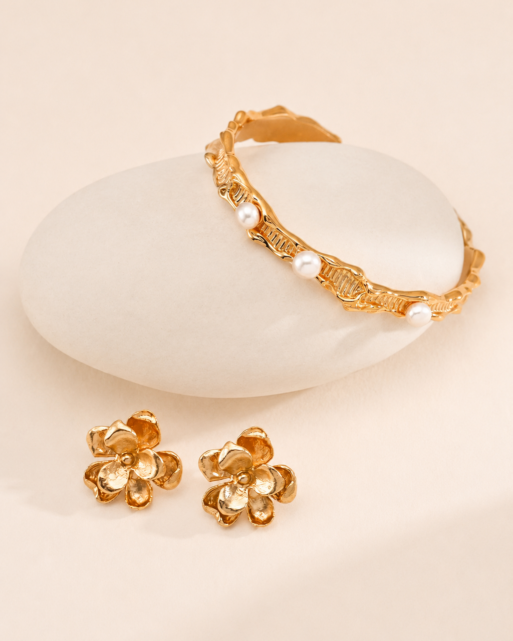 Gold flower stud earrings featuring sculpted petal details and a textured finish, elegant floral jewelry for everyday wear.