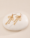 Gold pearl bow drop earrings with delicate ribbon design and pearl studs, elegant feminine jewelry for women.