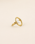 Halo Pearl Ring in 18K gold plated sterling silver with a natural freshwater pearl on a beige background.