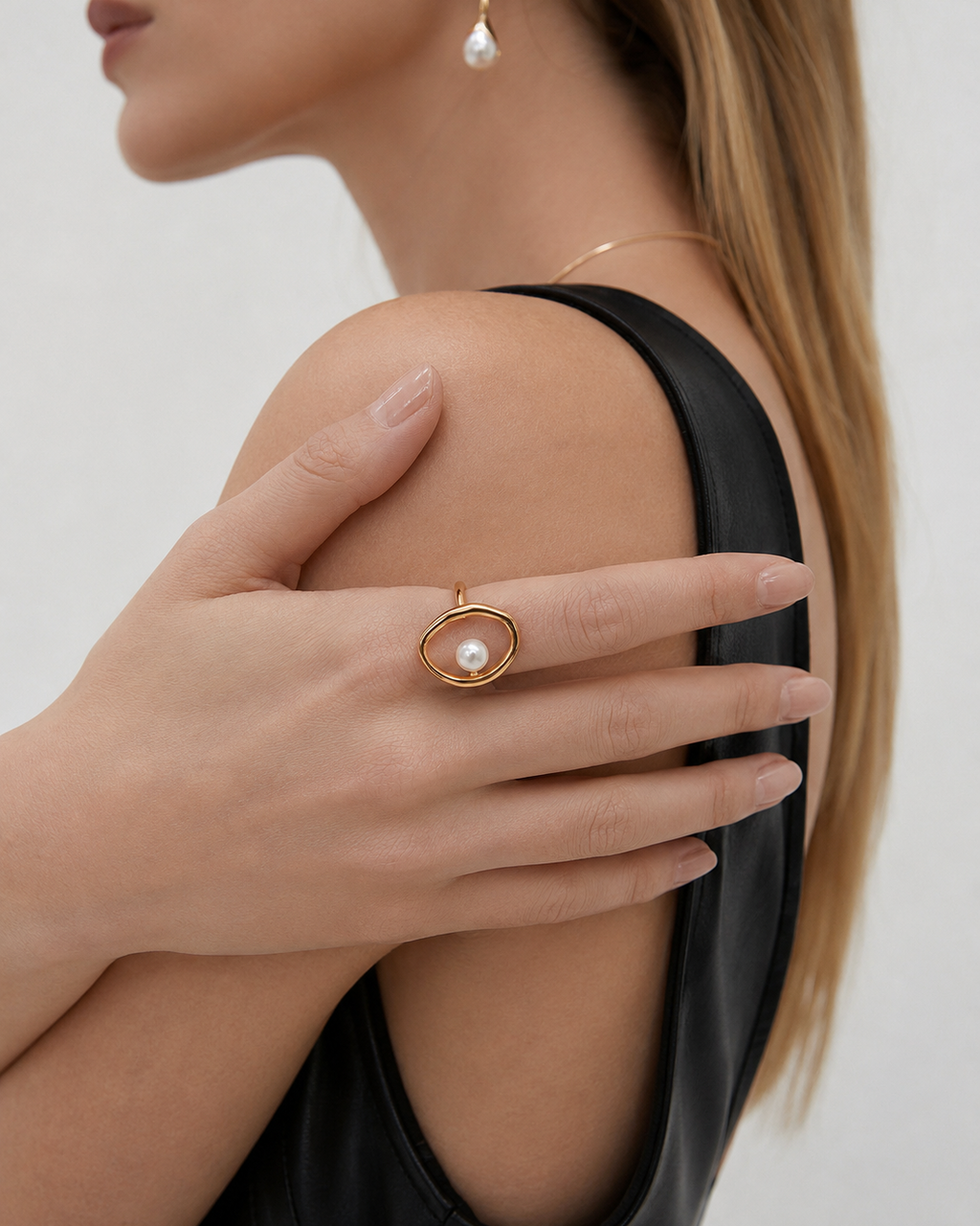 Model wearing the Halo Pearl Ring in 18K gold plated sterling silver with a natural freshwater pearl.