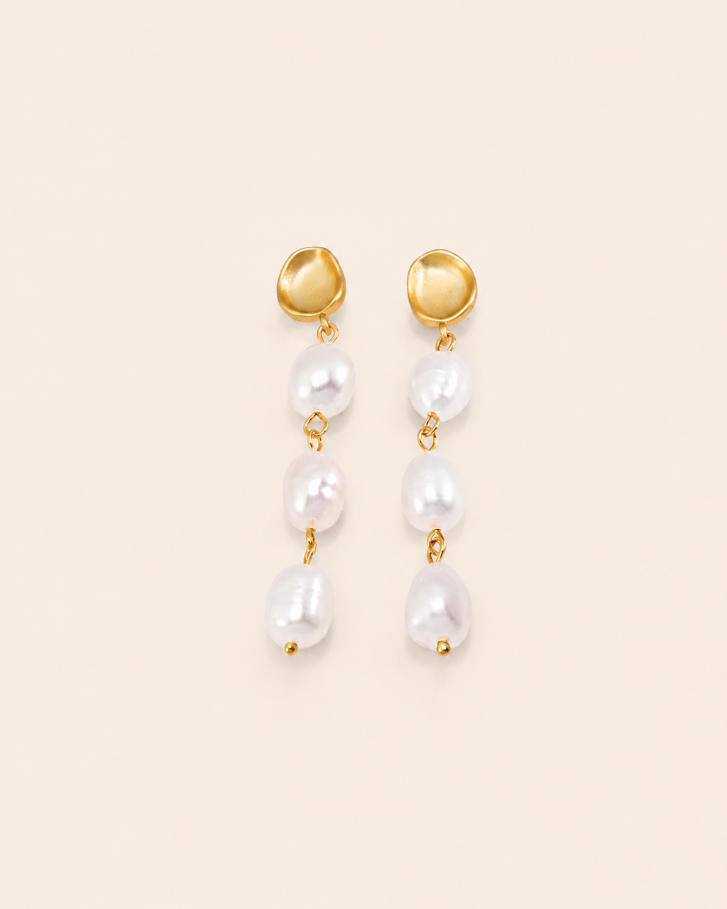 Elegant gold drop earrings featuring three freshwater pearls in a cascading design