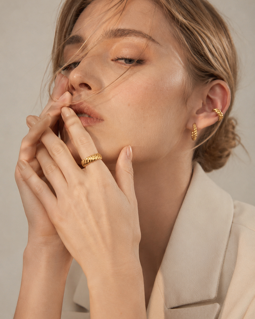 Close-up of a model wearing an adjustable rope texture ring in thick 18K gold plated sterling silver.