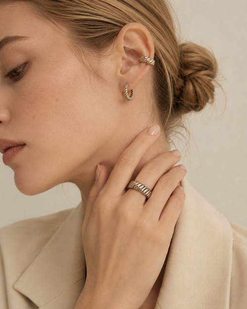 Model wearing an adjustable rope texture ring in thick 18K white gold plated sterling silver with matching hoop earrings.