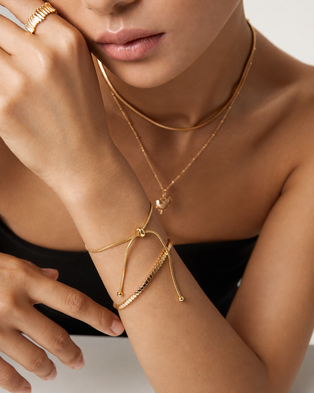 Woman wearing the Luna Slider Bracelet, a minimalist adjustable snake chain bracelet in gold.