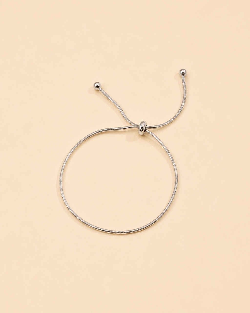 Minimalist white gold snake chain bracelet with adjustable slider clasp for everyday wear.
