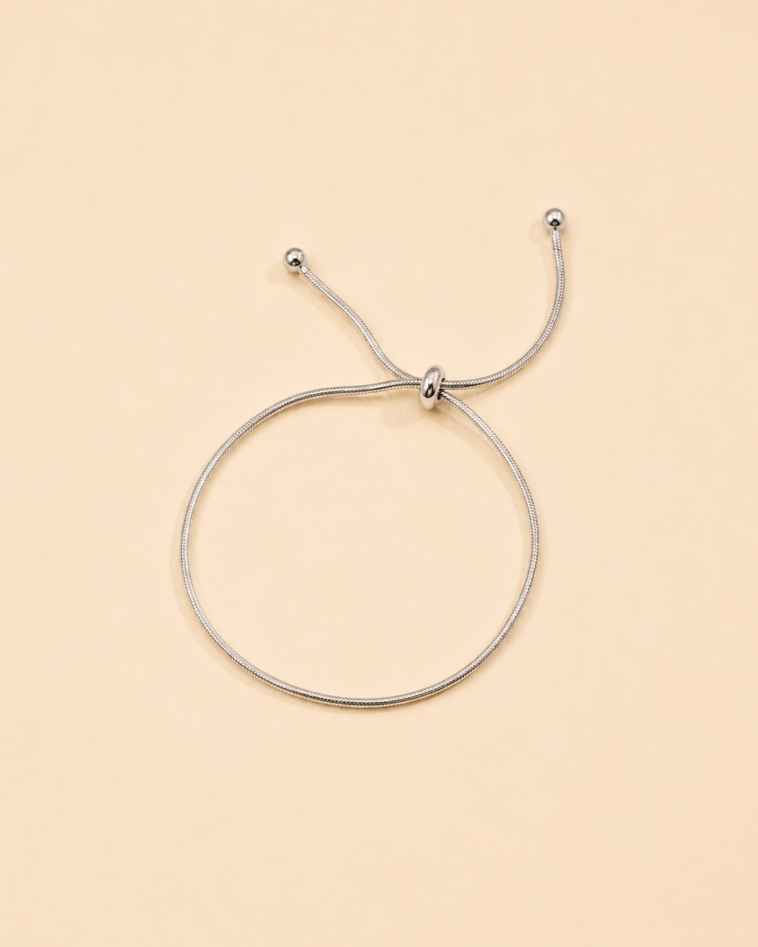 Minimalist white gold snake chain bracelet with adjustable slider clasp for everyday wear.