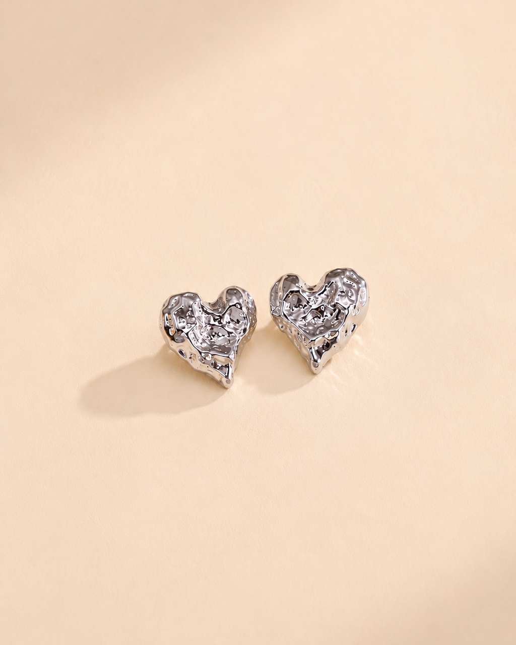 Melted Heart stud earrings in thick 18K white gold plating, crafted from S925 sterling silver with a modern textured heart silhouette.