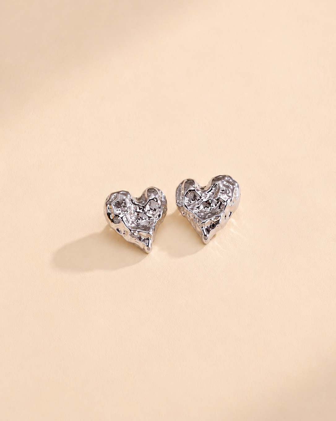 Melted Heart stud earrings in thick 18K white gold plating, crafted from S925 sterling silver with a modern textured heart silhouette.