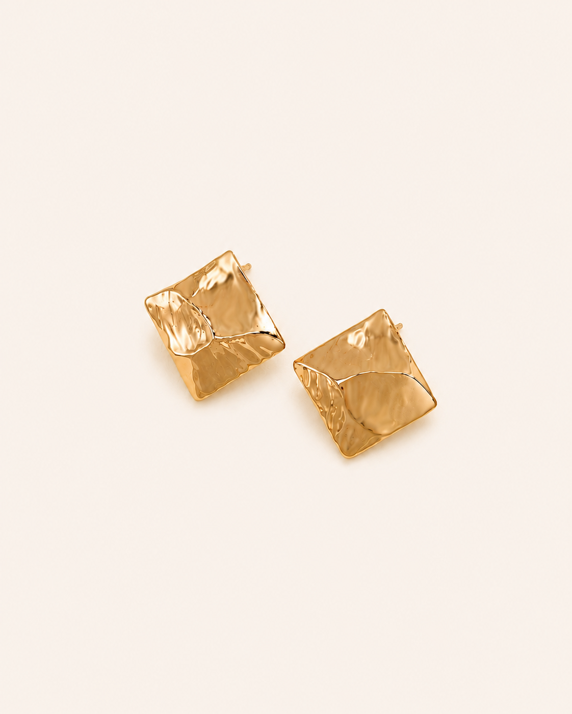 Model wearing Molten Square Stud Earrings featuring an organic textured gold design with a sculptural square silhouette.