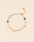 Noir Pearl Bracelet with freshwater pearls, black beads and crystal accents on a gold chain.