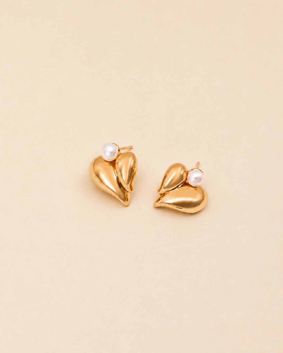 Vintage gold pearl heart stud earrings with natural freshwater pearls on a soft ivory background