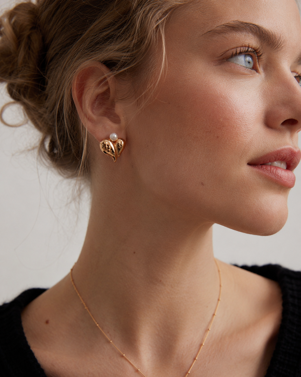 Model wearing vintage gold pearl heart stud earrings and matching pearl heart pendant necklace.