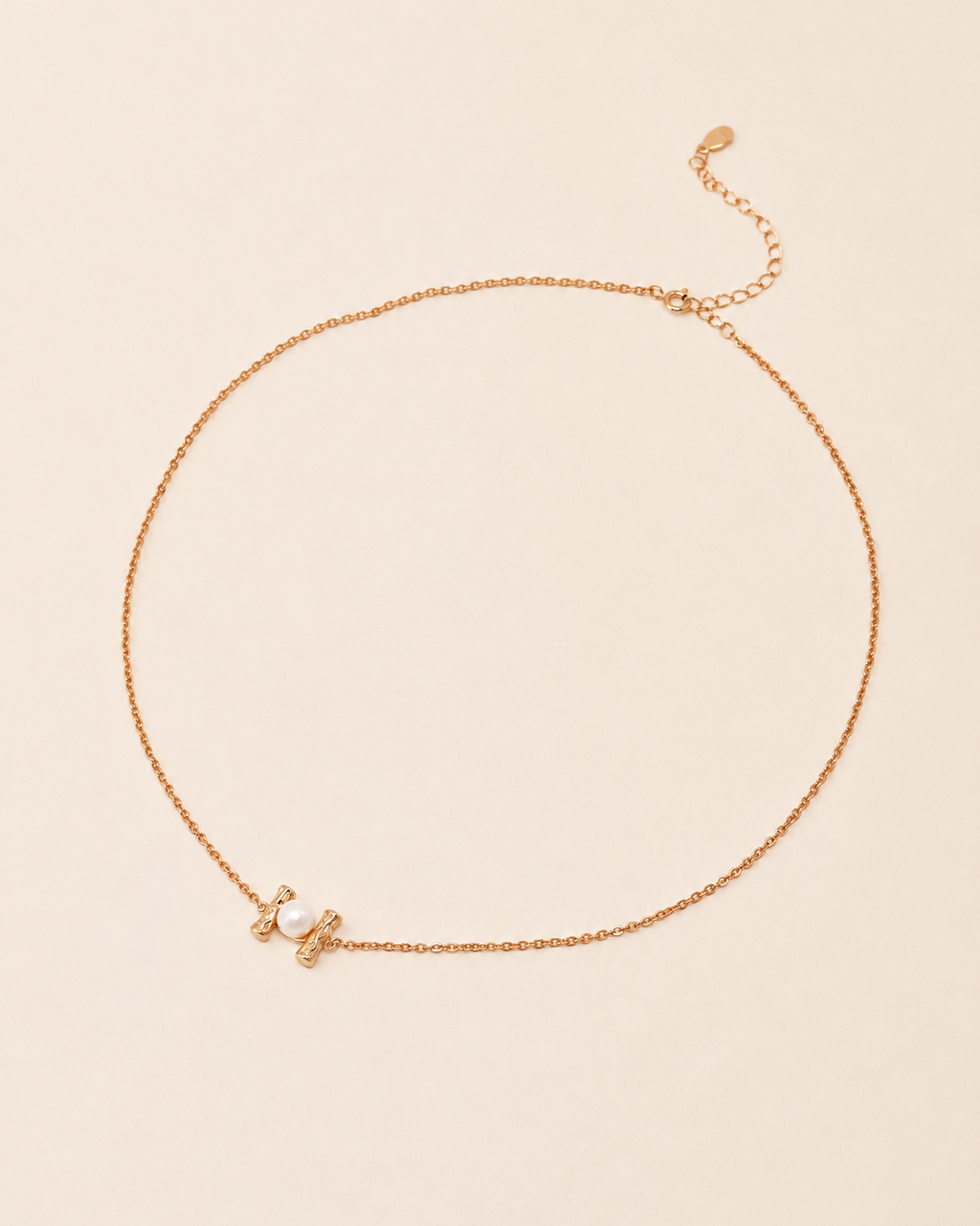 Pearl Whisper Necklace featuring a delicate gold chain with a freshwater pearl accent and adjustable extender chain.