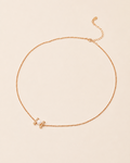 Pearl Whisper Necklace featuring a delicate gold chain with a freshwater pearl accent and adjustable extender chain.