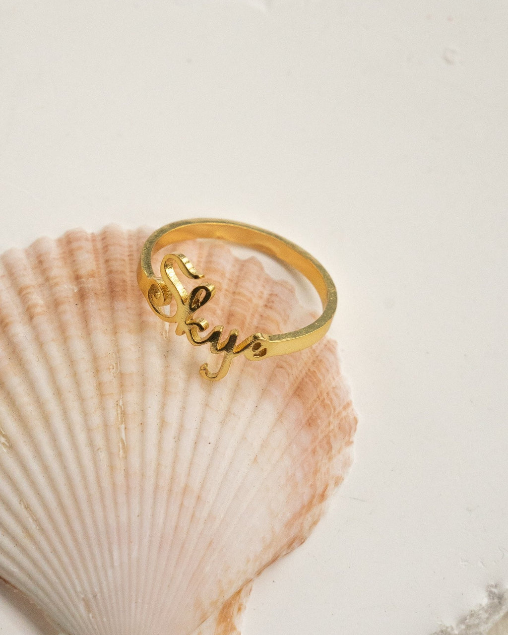 Personalized gold name ring in minimalist script design