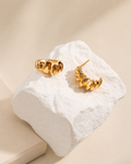Gold Ripple Huggie Earrings in 925 sterling silver with thick 18K gold plating featuring a sculptural organic design.