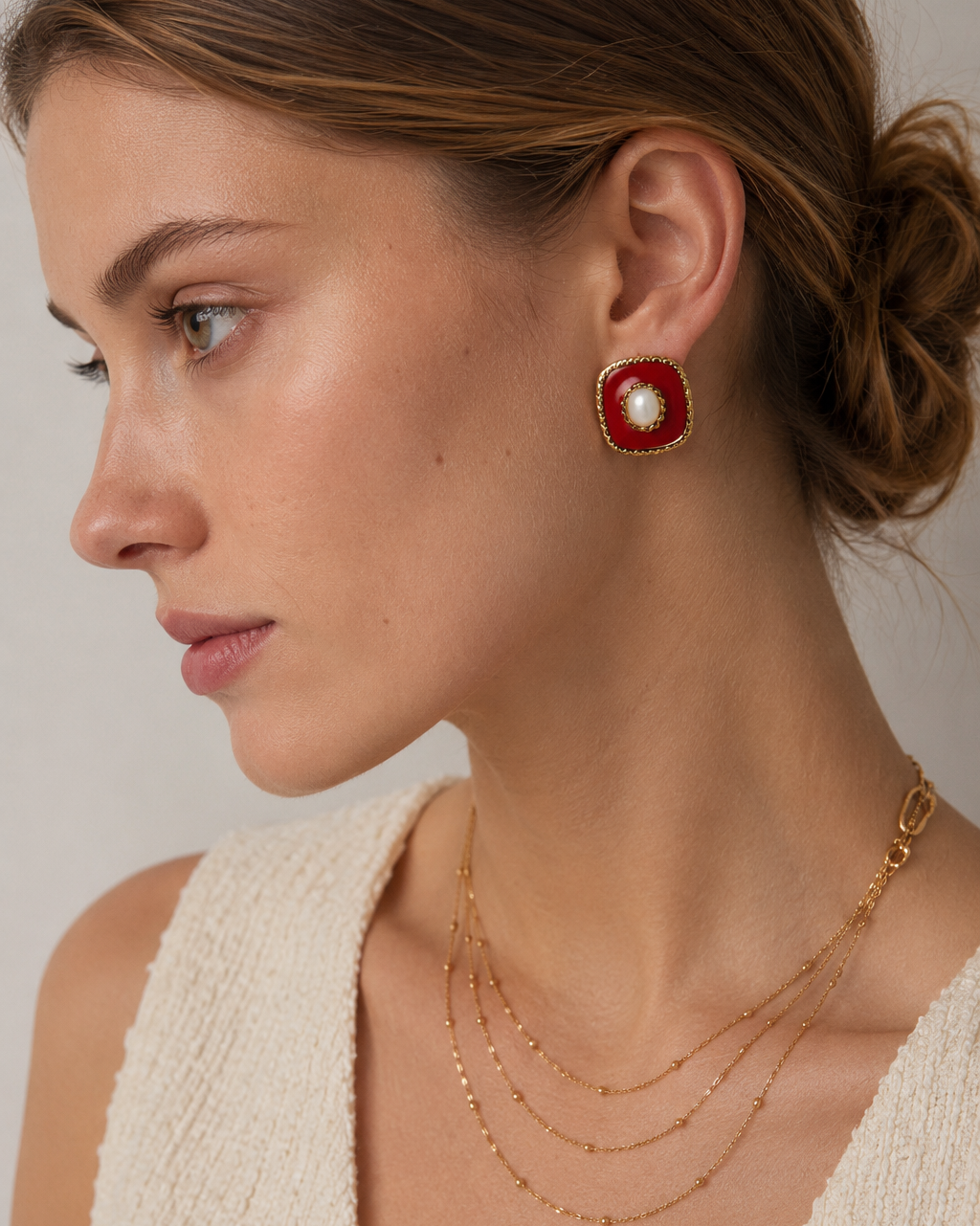 European model wearing vintage red enamel and shell stud earrings, showcasing the elegant square design and rich burgundy tones.