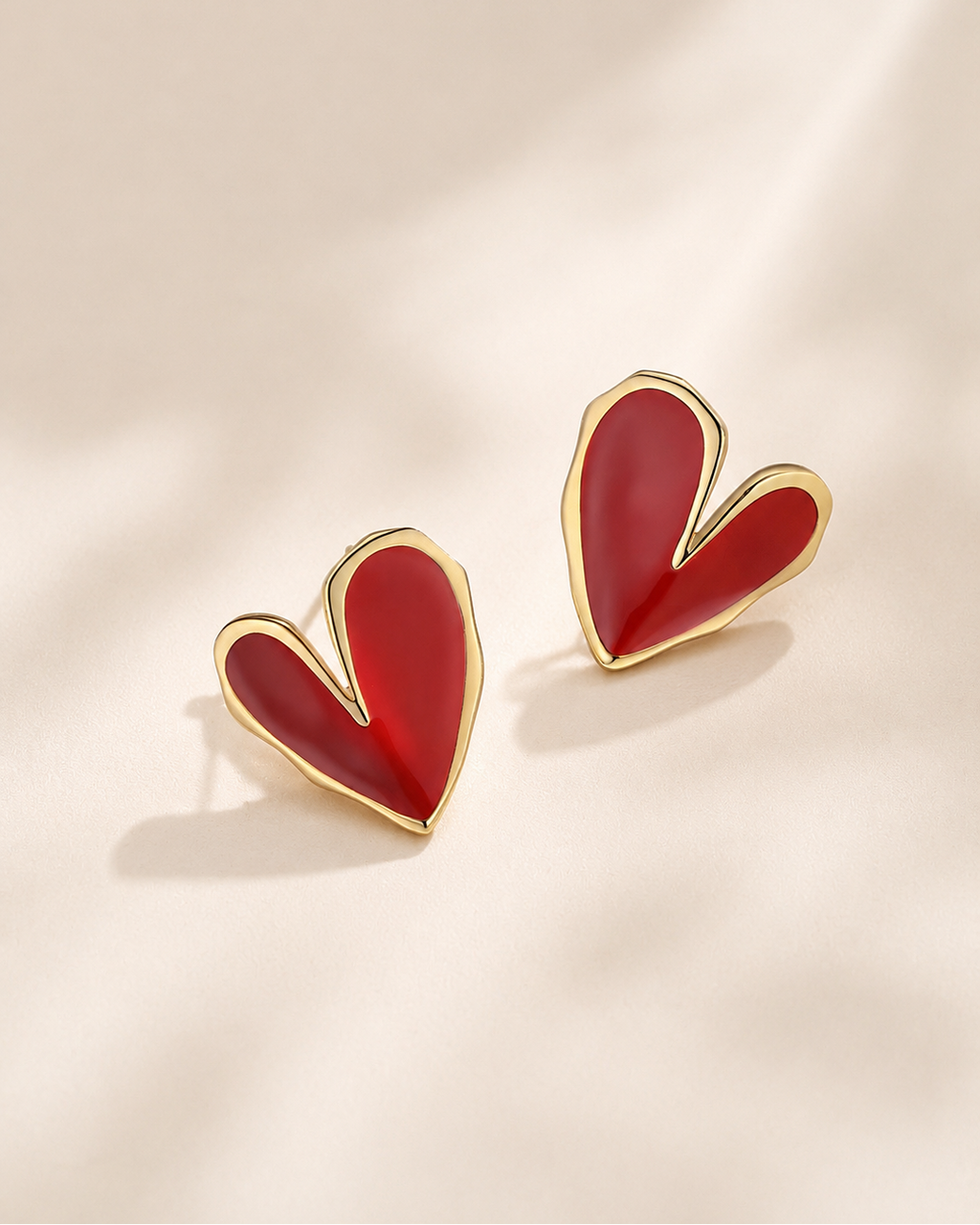 Red heart-shaped enamel stud earrings crafted in S925 sterling silver with 18K gold plating.