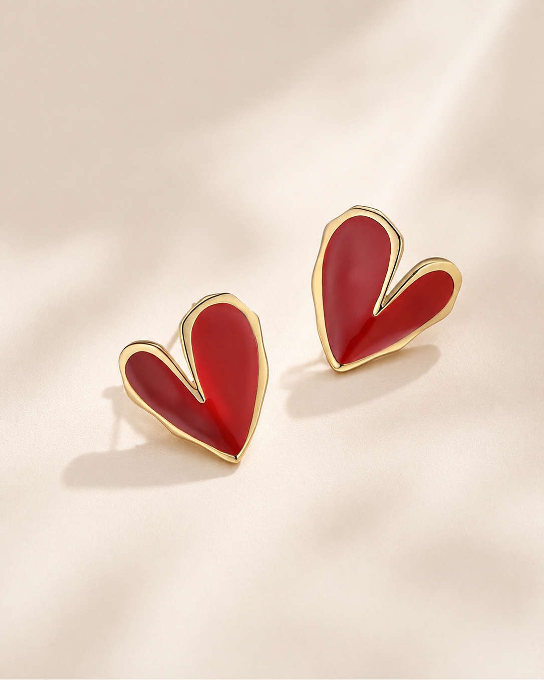 Red heart-shaped enamel stud earrings crafted in S925 sterling silver with 18K gold plating.